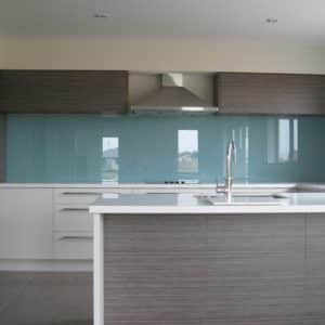 Grey based aqua coloured glass splashback